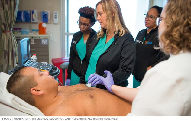 A man undergoes an echocardiogram of the chest.